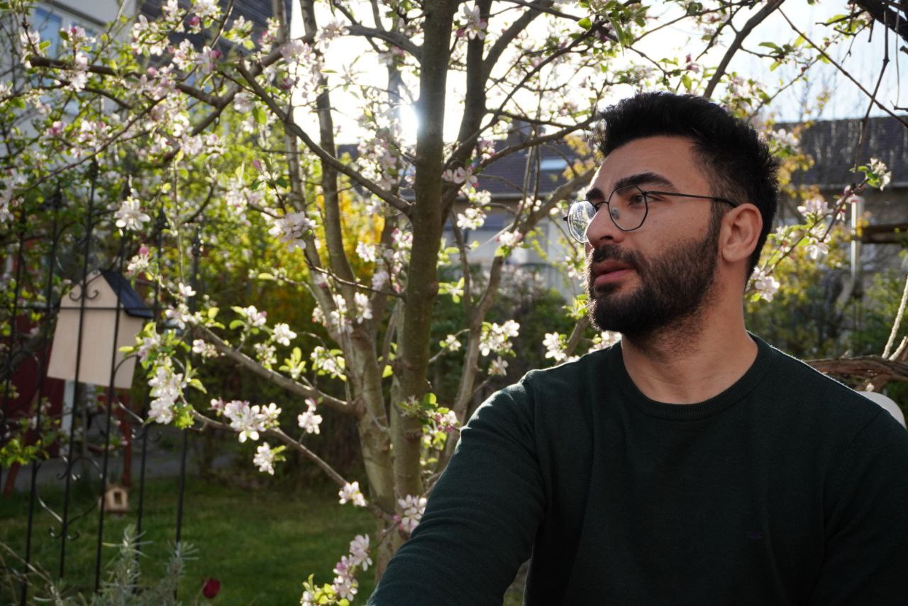 Alex walking in a casual outfit.