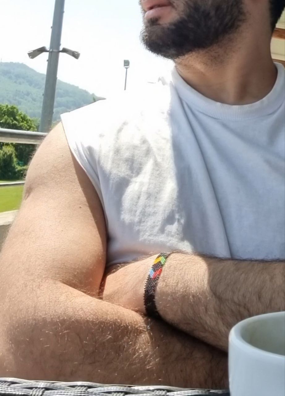 Alex focused on coding on his laptop in a stylish, minimalist workspace.