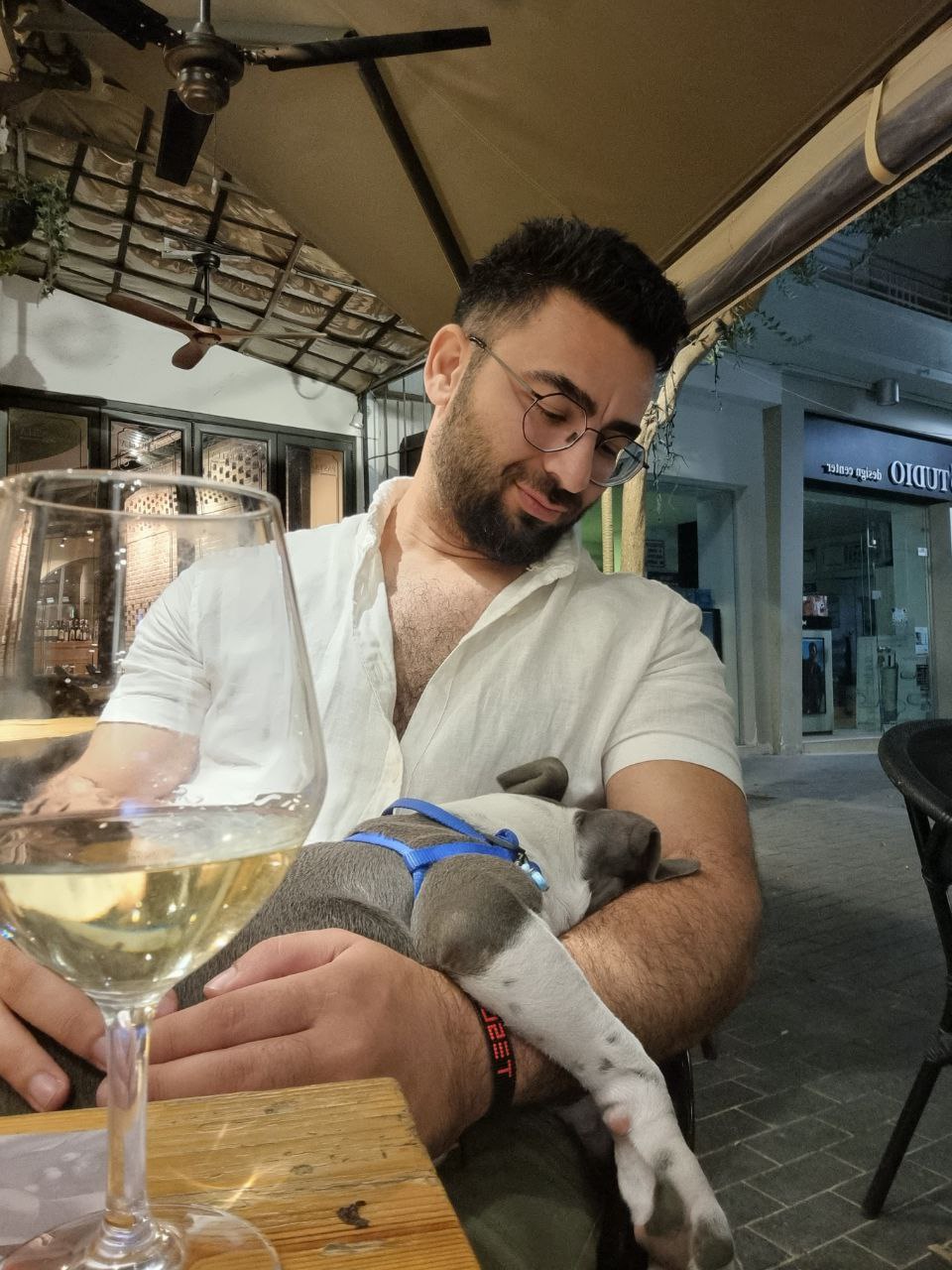 Alex driving a convertible car at sunset.